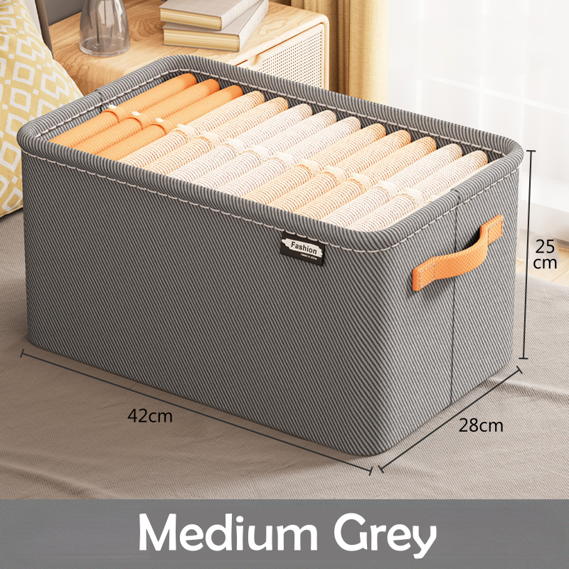 A clothing box organizer in a khaki color with visible side handles and a fabric build.