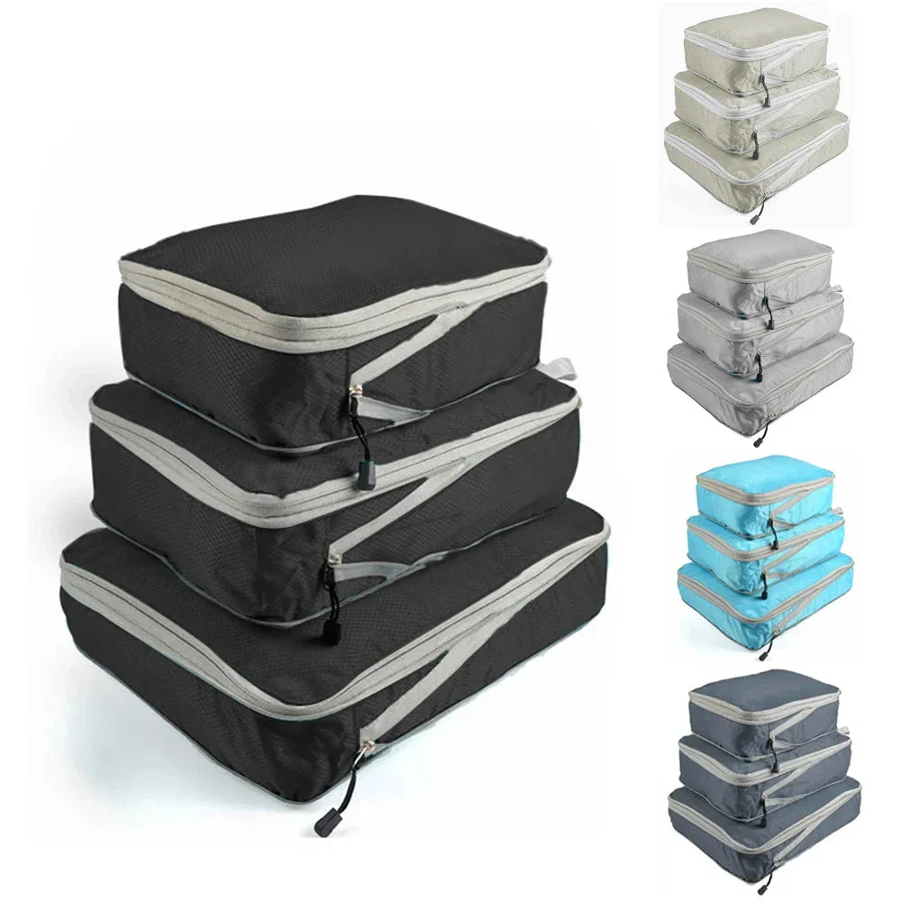 Set of three compression packing bags in black, with additional colors shown in blue and gray. Each bag has a zipper closure and a mesh side panel.