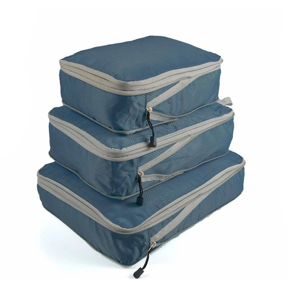 Set of three compression packing bags in black, with additional colors shown in blue and gray. Each bag has a zipper closure and a mesh side panel.
