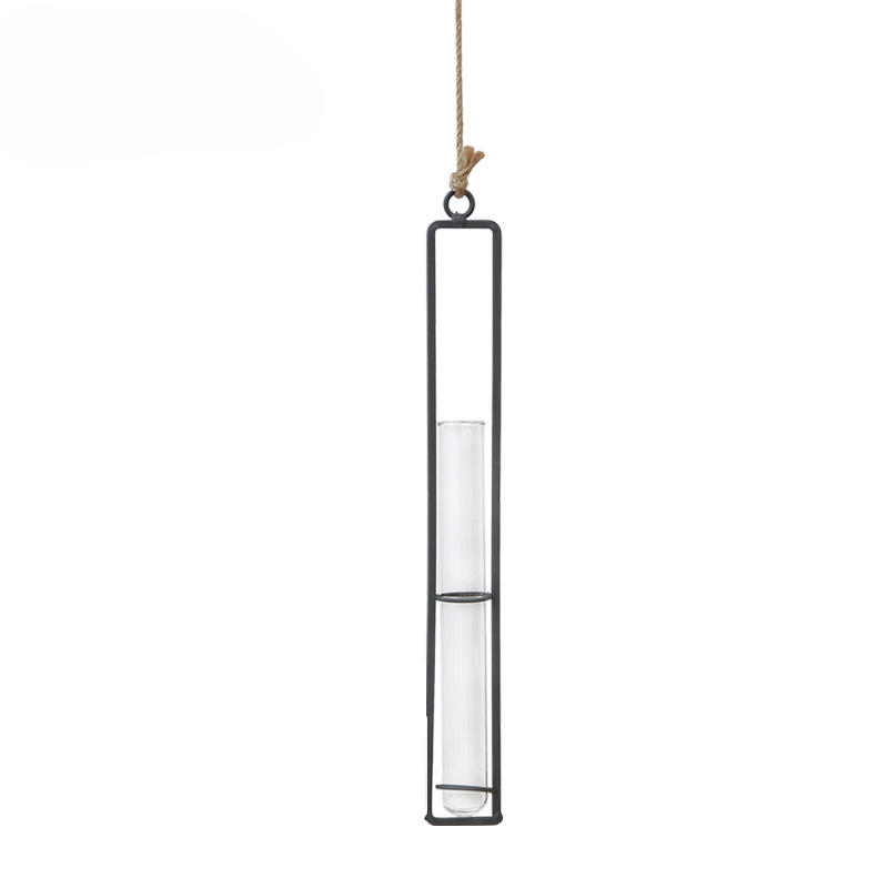 Hanging candle holder with clear glass and black metal frame on a white background