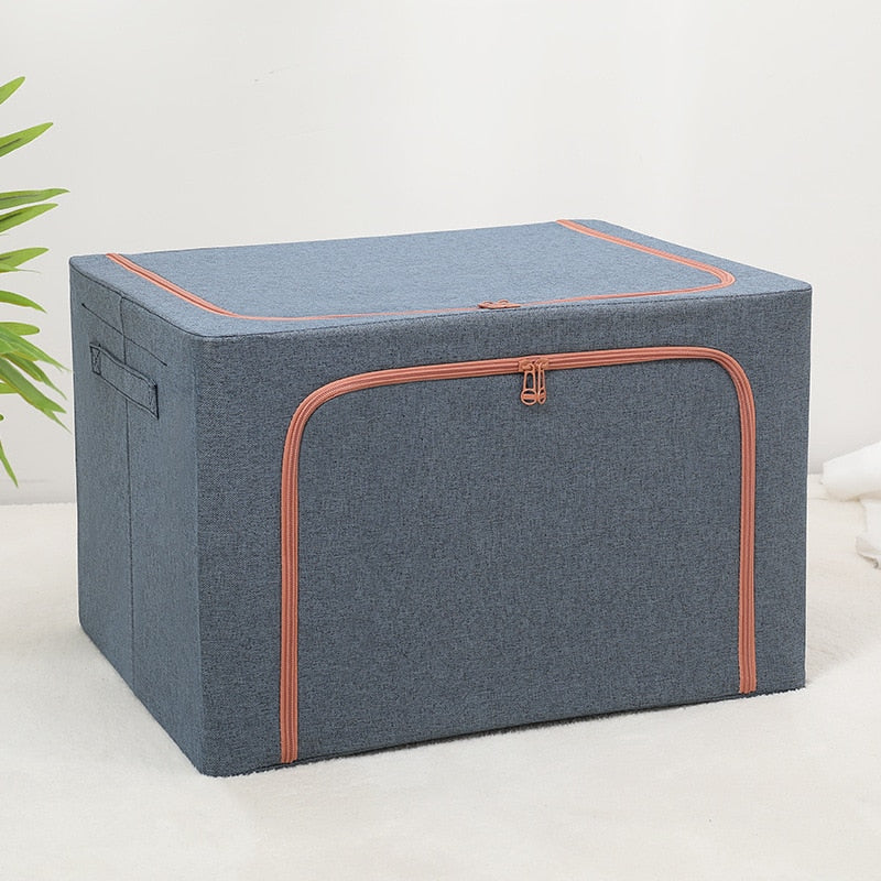 Foldable storage boxes in gray color with a side window, containing neatly folded multicolored items. The upper box is closed with a zipper, and the lower one is open, showing the items inside.