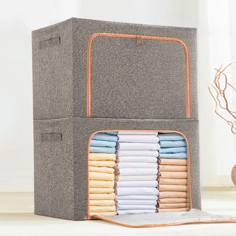 Foldable storage boxes in gray color with a side window, containing neatly folded multicolored items. The upper box is closed with a zipper, and the lower one is open, showing the items inside.