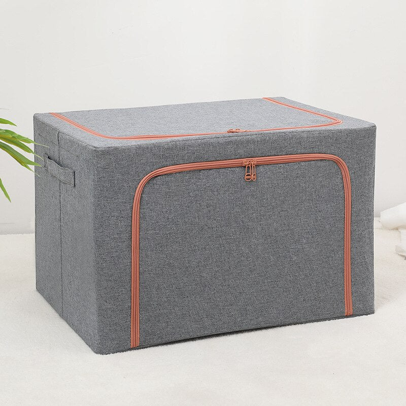 Foldable storage boxes in gray color with a side window, containing neatly folded multicolored items. The upper box is closed with a zipper, and the lower one is open, showing the items inside.