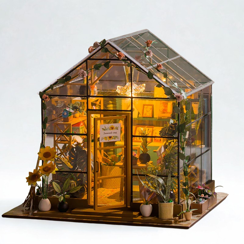 Model of a greenhouse with plants and lights on a white background