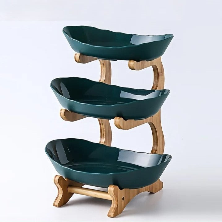 A set of multi-tiered snack bowls with a wood stand, available in beige, white, and turquoise colors, filled with various fruits.