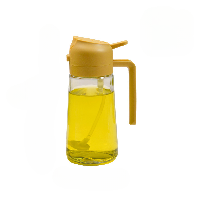 Yellow glass oil bottle with a yellow lid on a white background