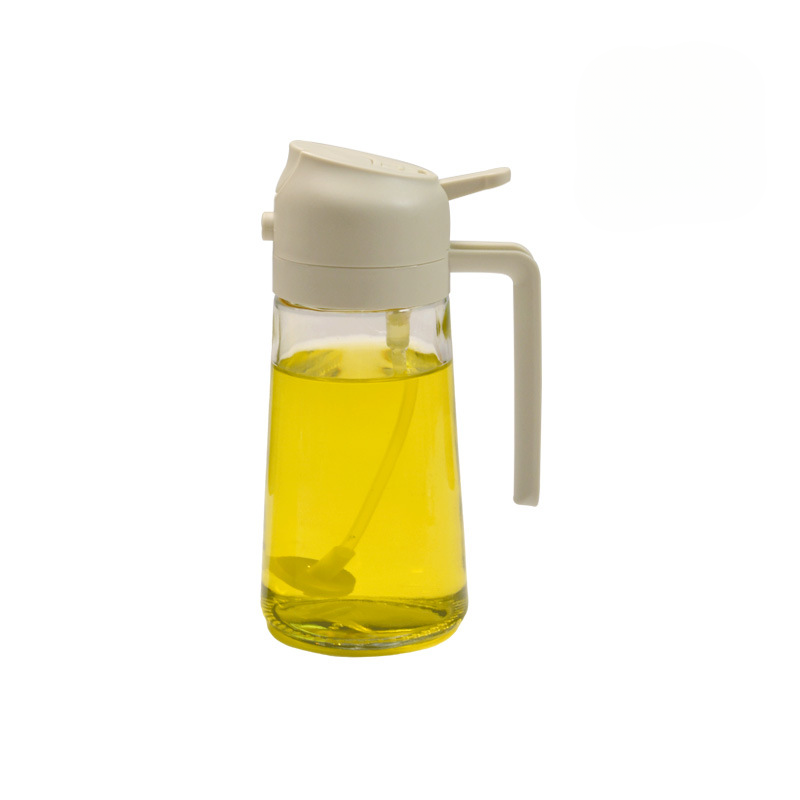 Glass oil bottle with beige cap and handle on a white background