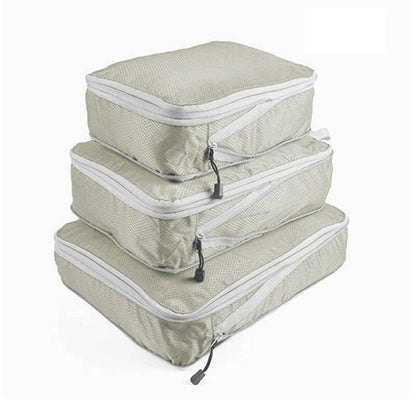 Set of three compression packing bags in black, with additional colors shown in gray. Each bag has a zipper closure and a mesh side panel.