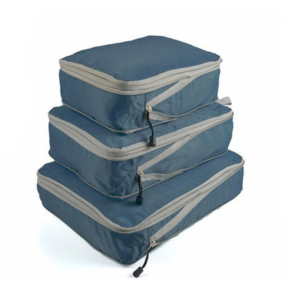 Set of three compression packing bags in black, with additional colors shown in blue and gray. Each bag has a zipper closure and a mesh side panel.