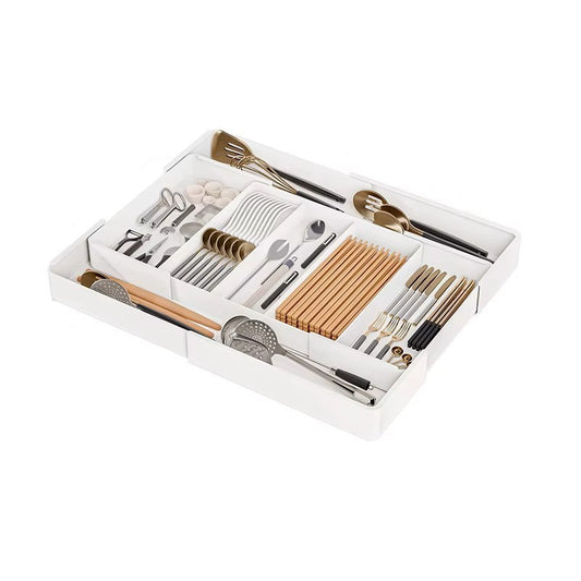 Set of cutlery and chopsticks in a white organizer on a white background