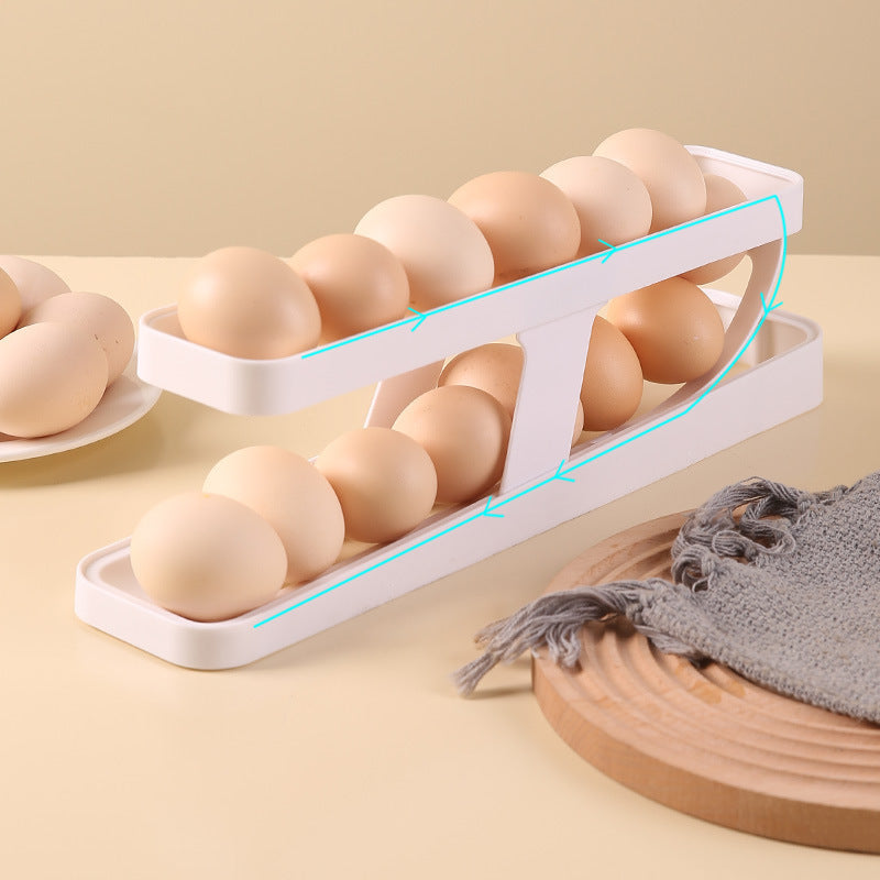 A white egg organizer resembling a sloped track capable of holding up to 14 eggs, placed on a beige surface with a few eggs on it and a grey napkin to the side.