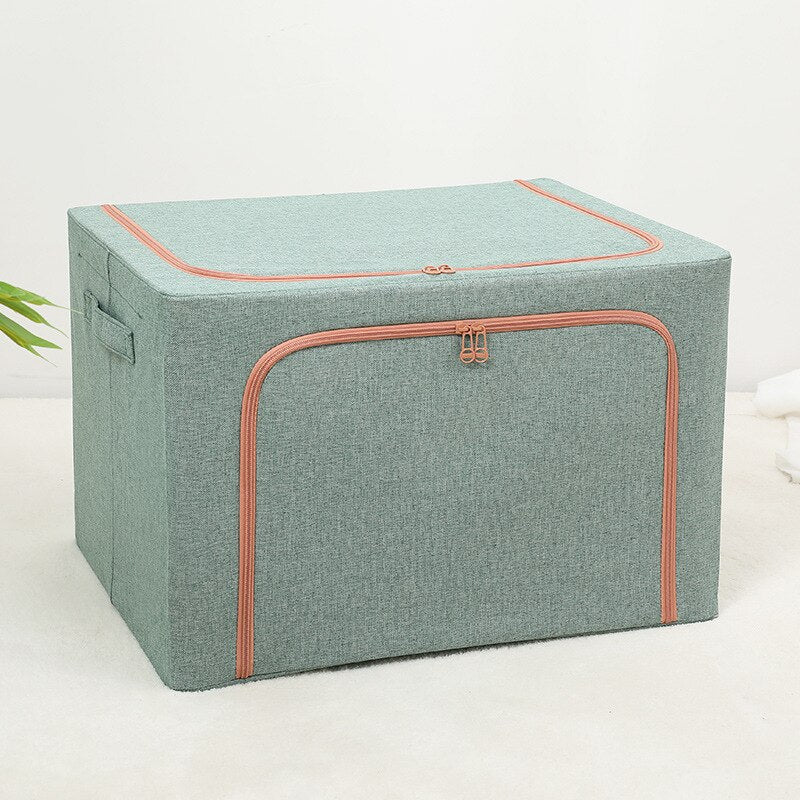 Foldable storage boxes in gray color with a side window, containing neatly folded multicolored items. The upper box is closed with a zipper, and the lower one is open, showing the items inside.