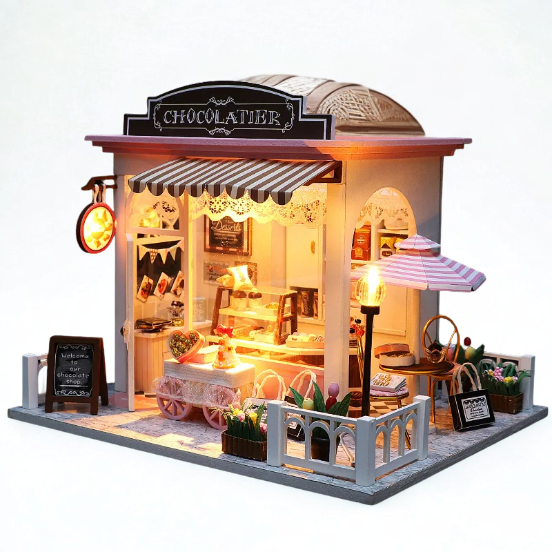 Model of a chocolate shop with detailed interior and exterior on a white background