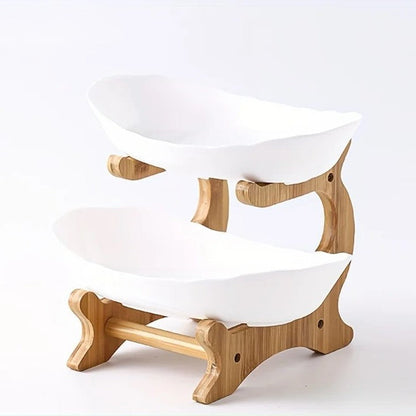 A set of multi-tiered snack bowls with a wood stand, available in beige, white, and turquoise colors, filled with various fruits.